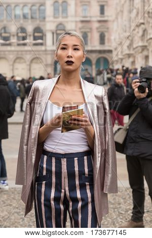 MILAN ITALY - FEBRUARY 23: Fashionable woman poses outside Genny fashion show during Milan Women's Fashion Week on FEBRUARY 23 2017 in Milan.