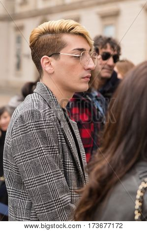 MILAN ITALY - FEBRUARY 23: Fashionable man poses outside Genny fashion show during Milan Women's Fashion Week on FEBRUARY 23 2017 in Milan.