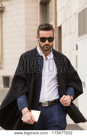 MILAN ITALY - FEBRUARY 23: Fashionable man poses outside Genny fashion show during Milan Women's Fashion Week on FEBRUARY 23 2017 in Milan.