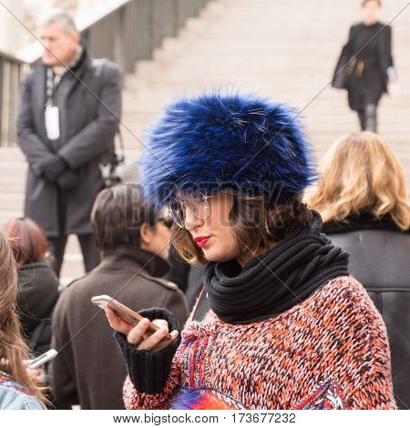 MILAN ITALY - FEBRUARY 23: Fashionable woman poses outside Genny fashion show during Milan Women's Fashion Week on FEBRUARY 23 2017 in Milan.