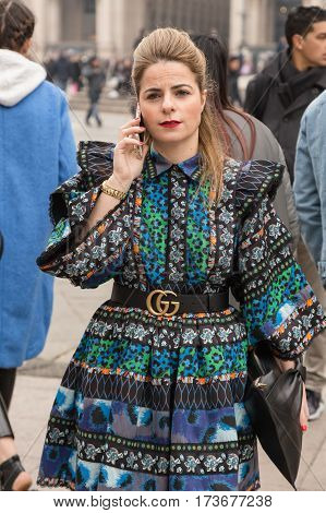 MILAN ITALY - FEBRUARY 23: Fashionable woman poses outside Genny fashion show during Milan Women's Fashion Week on FEBRUARY 23 2017 in Milan.