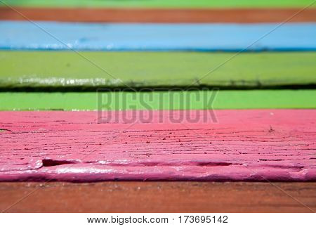 Patterned and textures background of brightly colored panels of weathered painted wooden boards