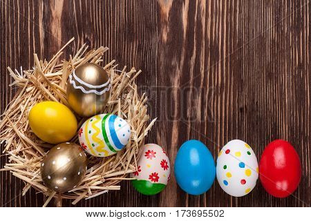 Colorful easter edds on a brown wooden table