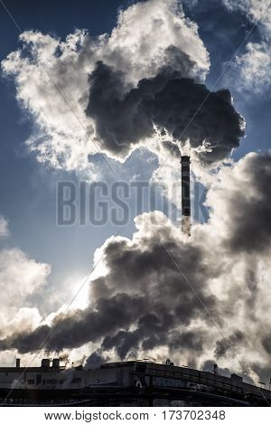 Smoking chimneys and shinning sun in factory Mondi Ruzomberok - Slovakia. Air pollution