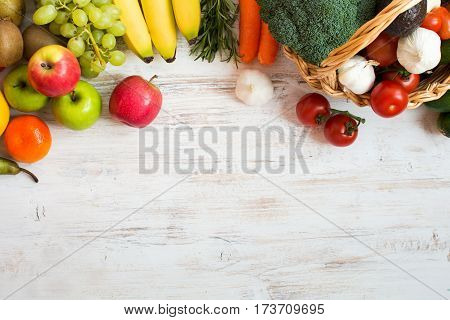 Variety of fruits and vegetables on the white wooden table top view copy space selecitve focus