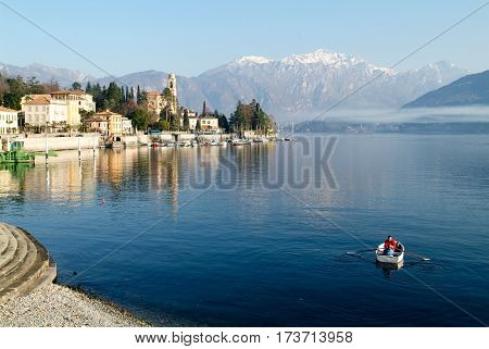 People On A Rowing Boat At The Coast Of Lake Como