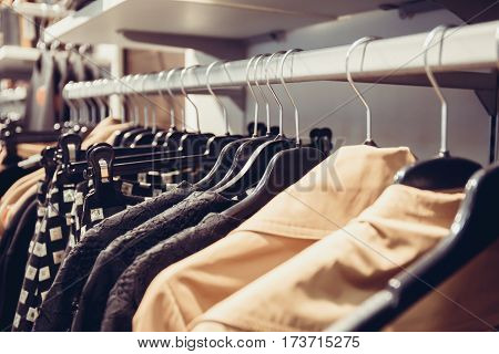different clothes naging on racks in boutique