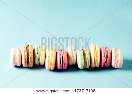 Pop art still life with colorfull macaroons on blue background