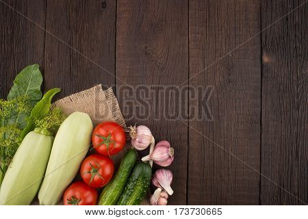 Ripe vegetables on an old wooden table. Top view.