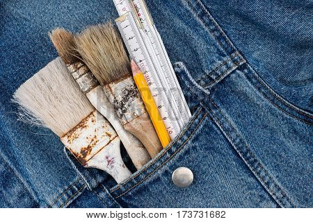 Brushes pencil in the pocket of denim triggers. Top view.