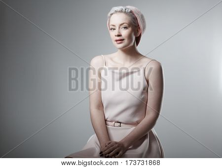 Studio photo of retro style woman, smiling.