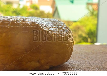 head of traditional Adygei cheese handmade on wooden Board