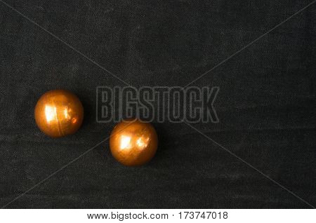pair of copper Chinese singing balls Baoding of health for hands on black background