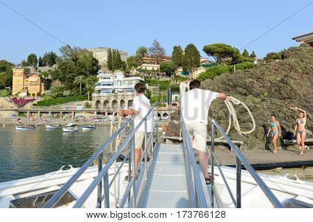 Levano Italy - 7 July 2015: sailors docking tourist boat at Levanto in Liguria Italy