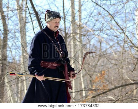 Kiev Ukraine- Februar25.2017: archer with a bow in the woods hunting.