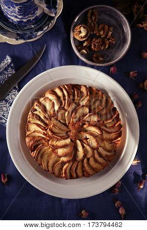 apple pie with walnuts on the blue tablecloth