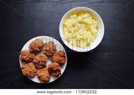Delicious meal of minced meat . Meat loaf with potatos on white plate  potato salad.