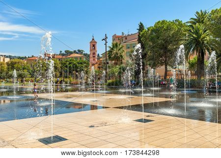 NICE, FRANCE - SEPTEMBER 02, 2015: People among fountains at Promenade du Paillon - 12 hectares, 1.2km long new green pedestrian walkway area in the heart of Nice opened on October 26, 2013.