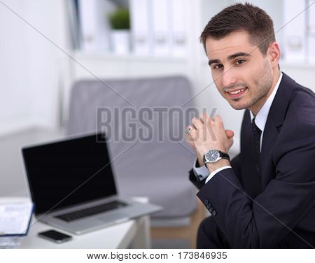 young businessman sitting in his office on sota