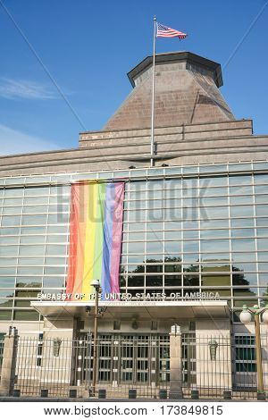 OTTAWA, CANADA - AUGUST 19, 2014: Flag LGBT on USA Embassy in OTTAWA, CANADA. American flag on the sky background.