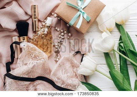 Stylish Craft Present Box And Lace Lingerie Jewelry And Perfume Present On Soft Fabric And Tulips On