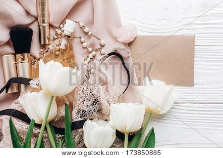 Stylish Woman Set. Lace Lingerie Jewelry And Perfume And Greeting Card On Soft Fabric And Tulips On