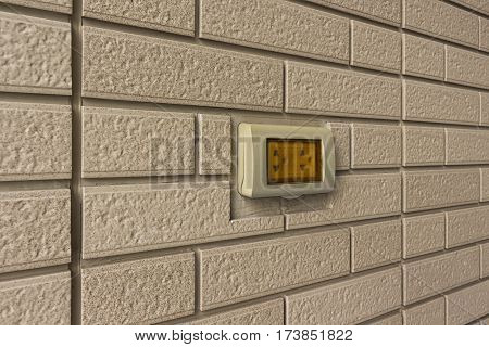 A Socket with cover for outdoor in a brick wall