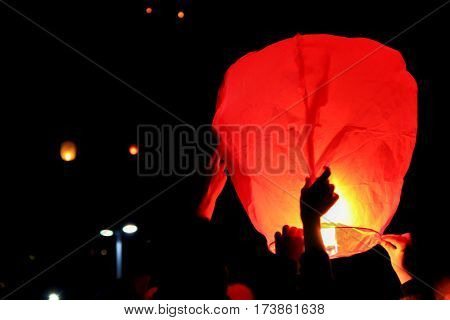 people releasing Skylanterns to sky at night