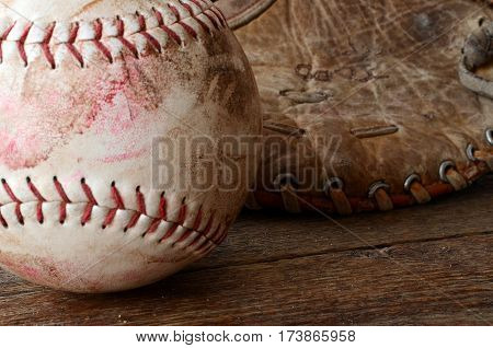 A close up image of old and dirty baseball equipment.