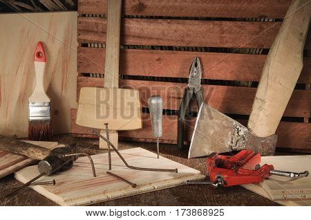 Stylized old tools on wooden table in a joinery.