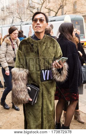 MILAN ITALY - FEBRUARY 23: Fashionable man poses outside Fendi fashion show during Milan Women's Fashion Week on FEBRUARY 23 2017 in Milan.