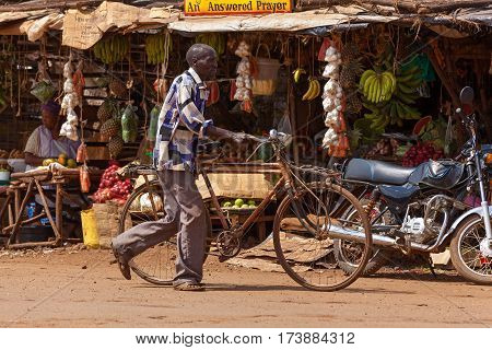 Nairobi Kenya - 07 Januar 2013 a man rolls a bicycle down streetpeople in Kenya