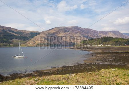Sailing boat on Loch Leven Scottish lake Scotland Scottish Highlands with mountains