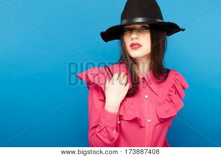 Beautiful Woman In Hat. Retro Fashion. Blue Background.