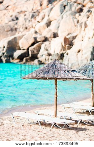 Beach chairs on exotic tropical white sandy beach