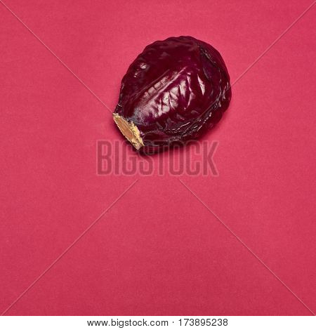 The fresh red cabbage on a red background