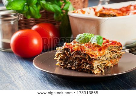 Piece Of Tasty Hot Lasagna With Spinach On A Plate
