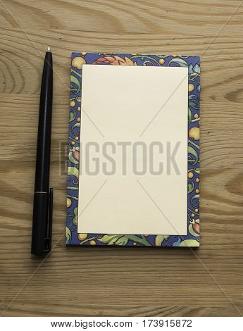 Colored sheet for notes and a green pen on a white background can. It can be used to add custom text.