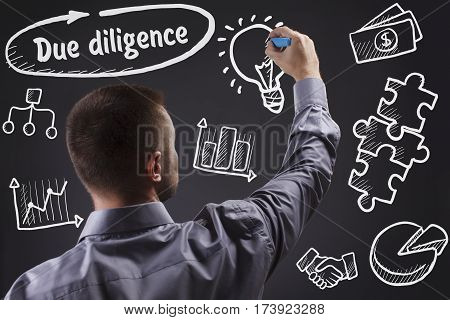 Technology, Internet, Business And Marketing. Young Business Man Writing Word: Due Diligence