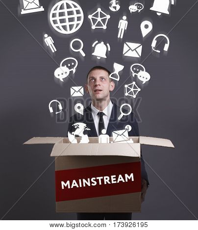 Business, Technology, Internet And Network Concept. Young Businessman Shows The Word: Mainstream