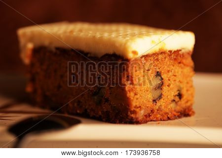 a slice of pumpkin cake on a white plate, tasy dessert