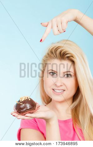 Woman Holding Chocolate Cupcake About To Bite