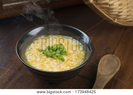Asian style porridge bowl on wooden table background.