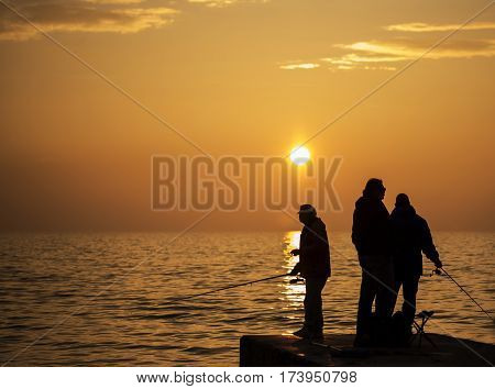 Piran Slovenia EU - Februar 18 2017: A group of fishermans are catching fish for a hobby and relaxing themselves in the meantime.
