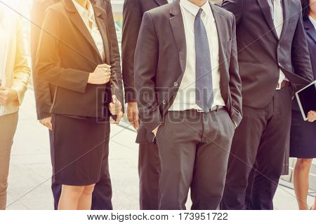 Group of happy young business team businesspeople walking the outdoor office together Success teamwork concept.