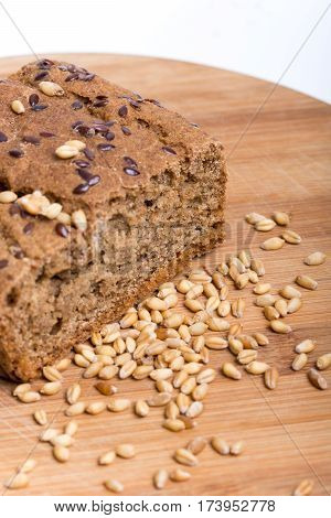 Chrono Bread On A Wooden Board With Grains Of Wheat