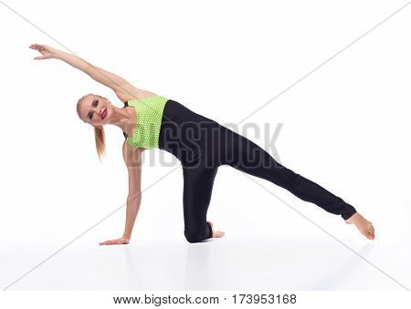 Best morning workout. Sporty young female working out isolated on white smiling joyfully wearing sexy sports outfit isolated