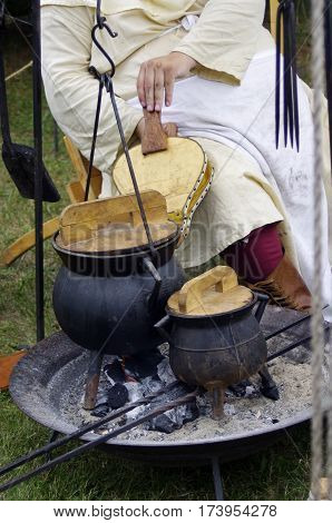 Historic Outdoor, medieval cooking on a fire with black pots