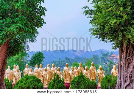 Gold buddhist statues with nature and trees