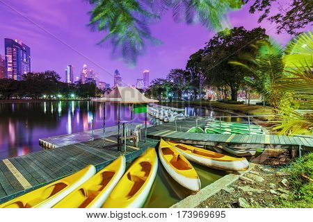 Lake with boats in Lumphini park at night